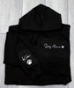 Black hoodie with 'Dog Mama' and paw print design on a wooden surface