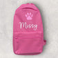 Pink backpack with a paw print and 'Missy' text on a light gray background