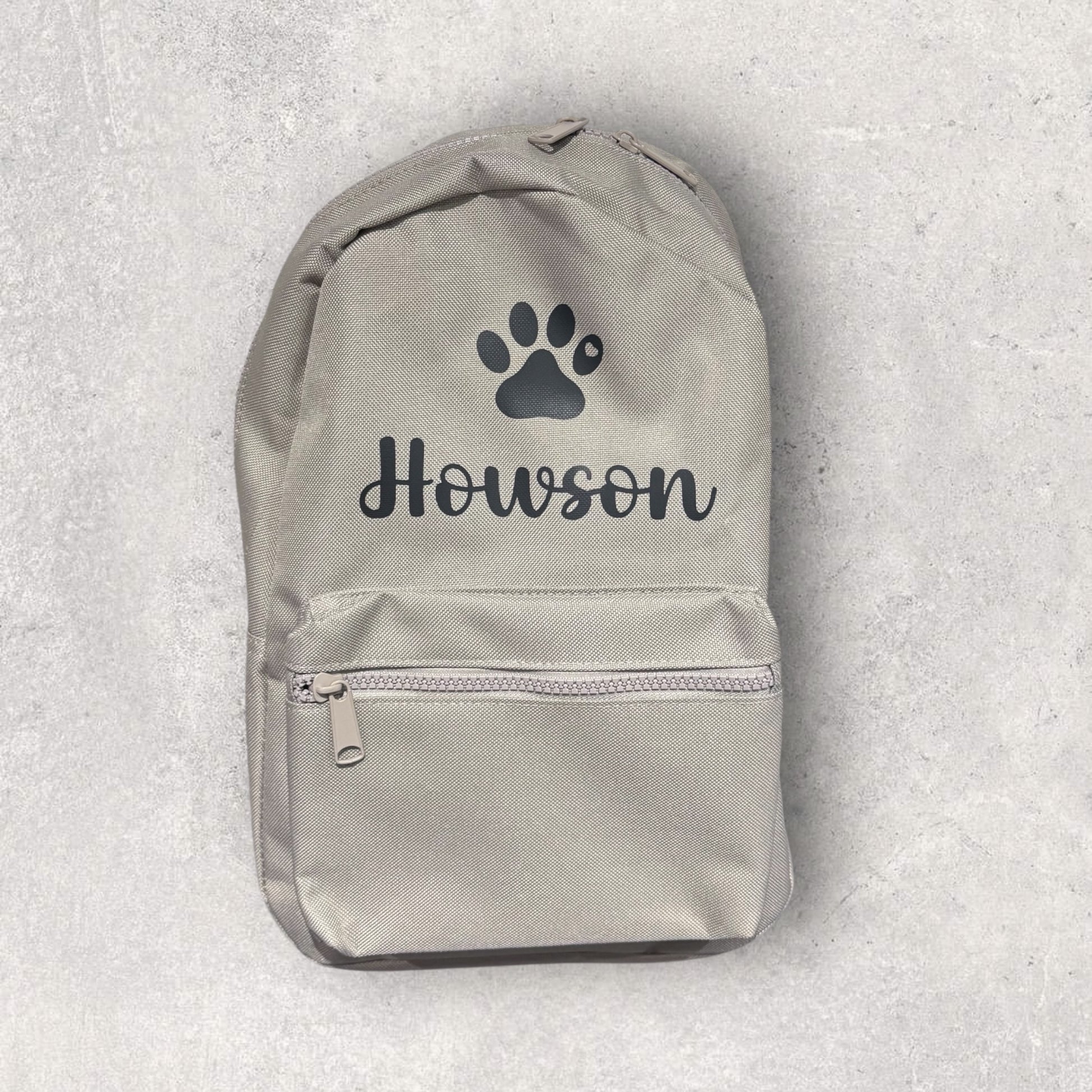 Gray backpack with paw print and 'Howson' text on a light gray background