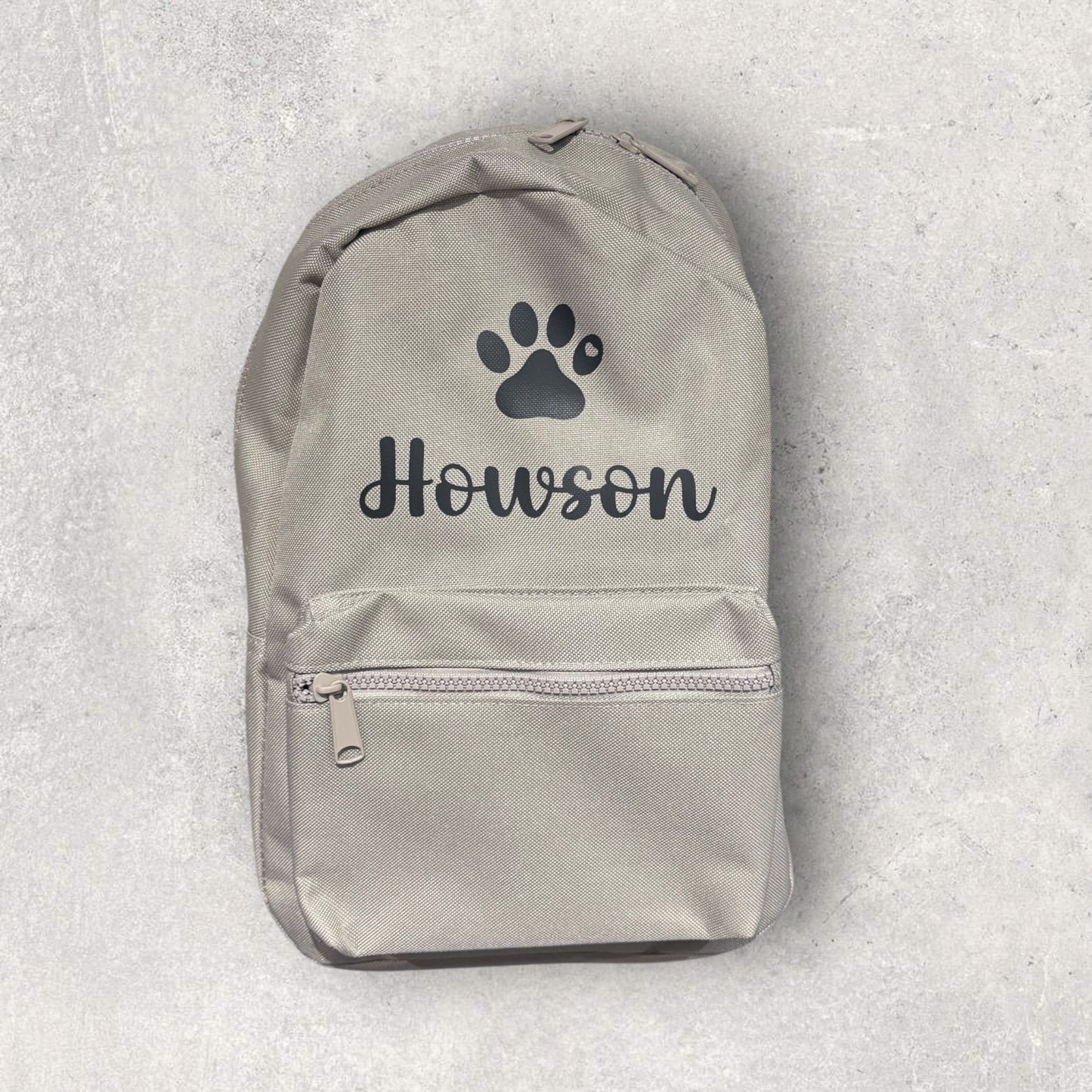 Gray backpack with paw print and 'Howson' text on a light gray background