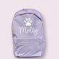 Light purple backpack with a white paw print and 'Molly' text on a light gray background