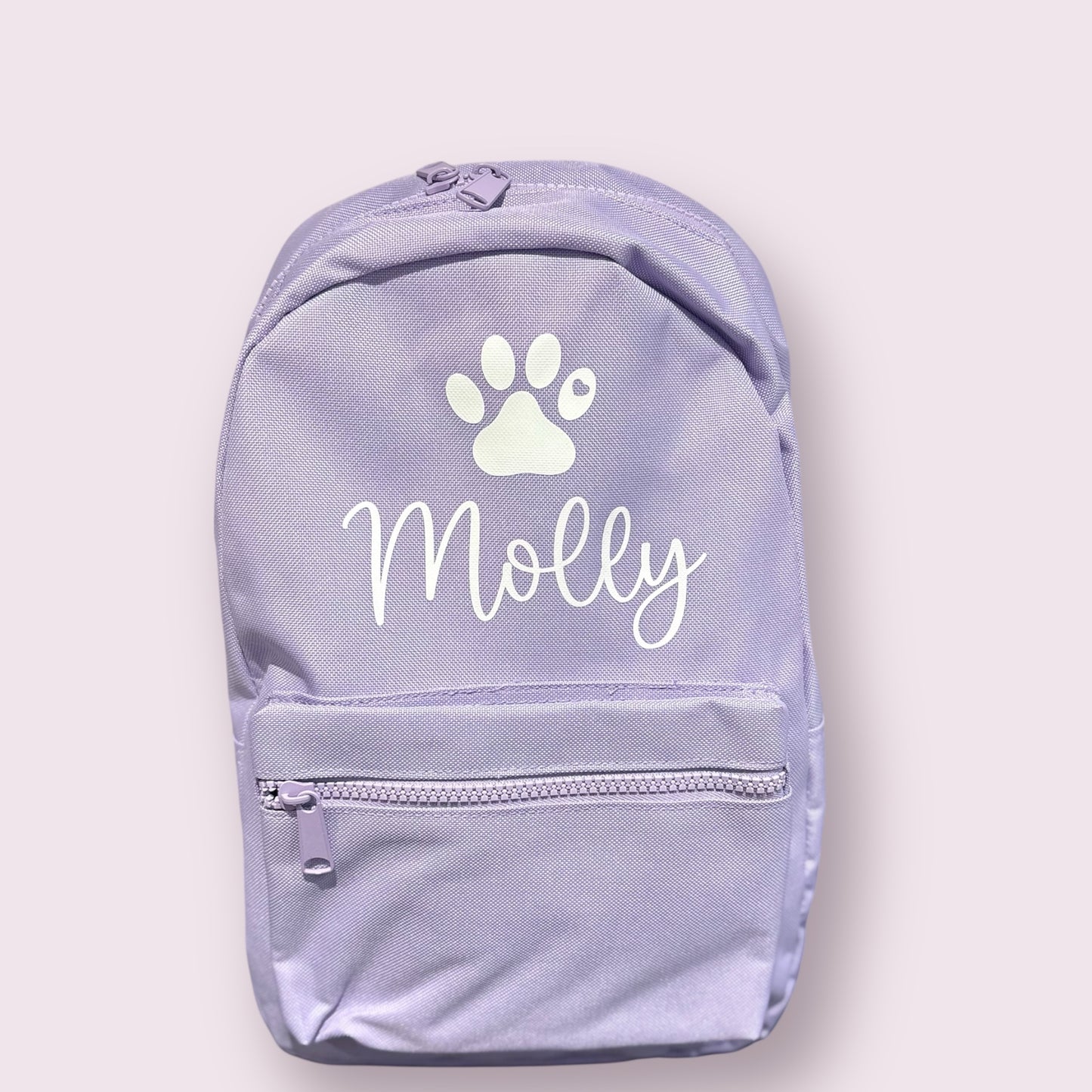 Light purple backpack with a white paw print and 'Molly' text on a light gray background