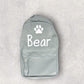 Gray backpack with 'Bear' and a paw print on a light gray background