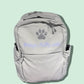 Gray backpack with a paw print design on a light green background