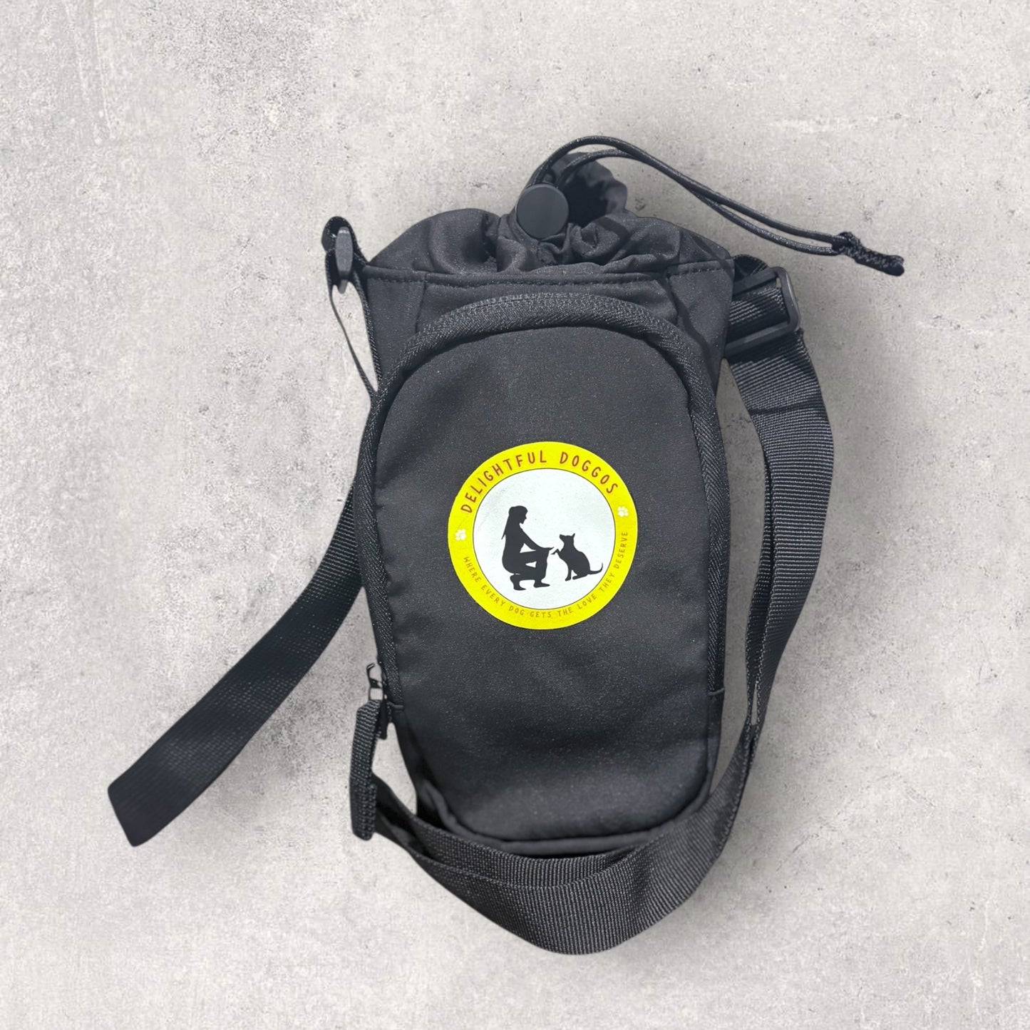 Black bottle bag with a yellow and white logo on a gray background