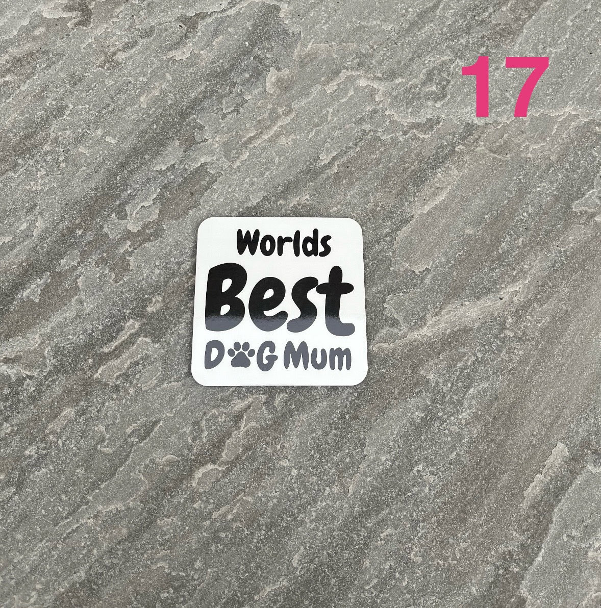Sticker with 'Worlds Best Dog Mum' text on a textured gray background