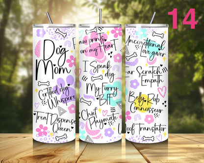 Three tumblers with dog-themed text designs on a wooden surface with a blurred natural background.