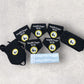 Set of black dog bandanas with 'Delightful Doggos Bestie' labels on a gray surface