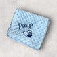 Blue textured blanket with 'Ponyo' and a paw print on a light gray background