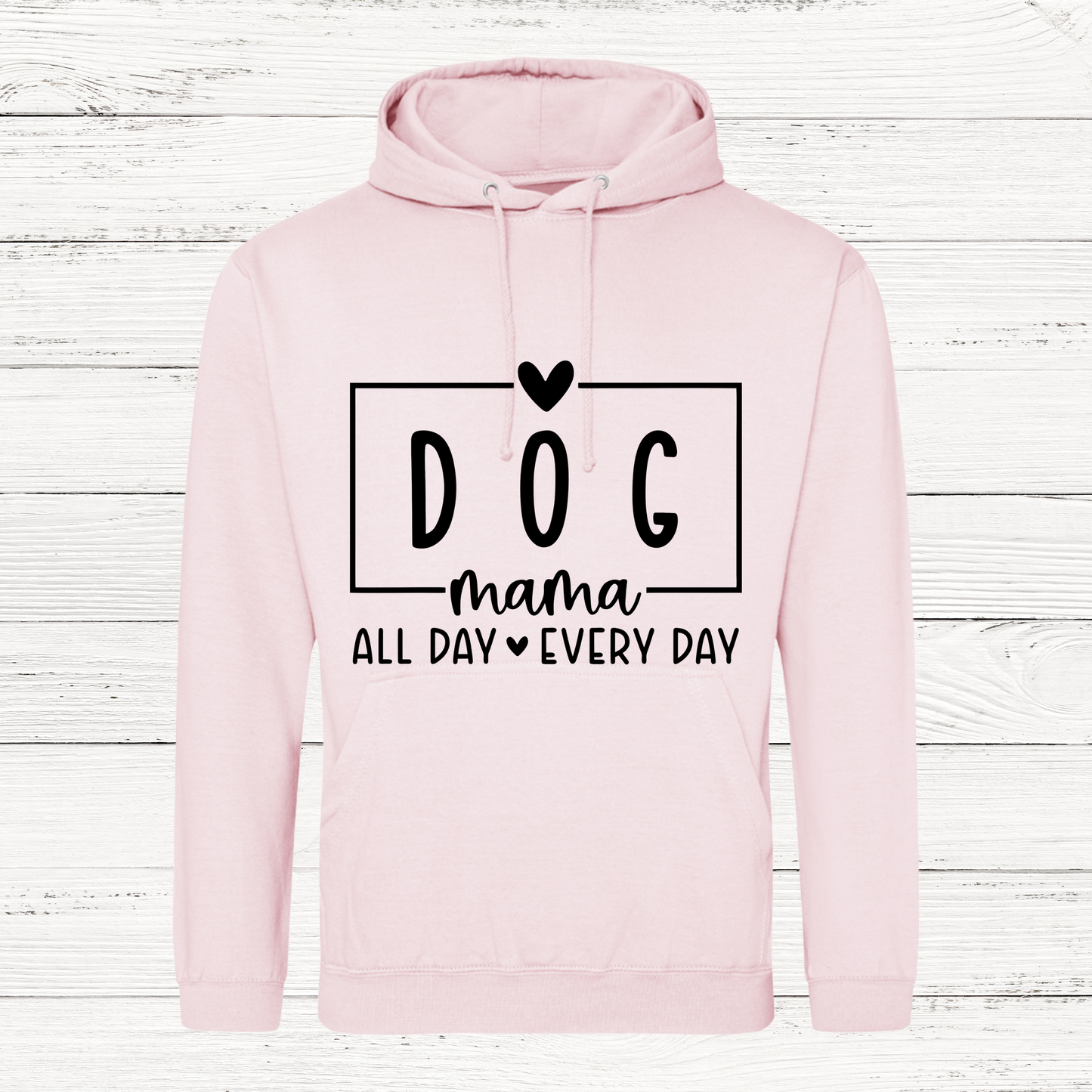 Pink hoodie with 'DOG mama all day every day' text on a wooden background