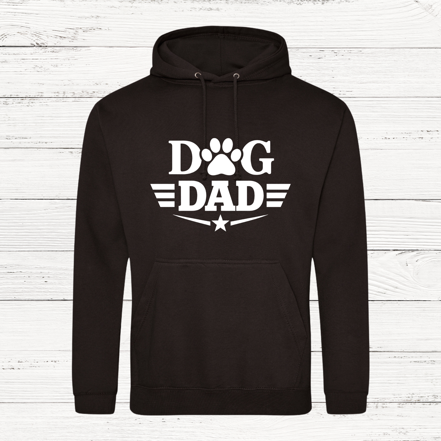 Black hoodie with 'Dog Dad' text on a white wooden background