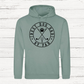 Sage green hoodie with 'Best Dog Dad by Par' text and graphics on a white wooden background