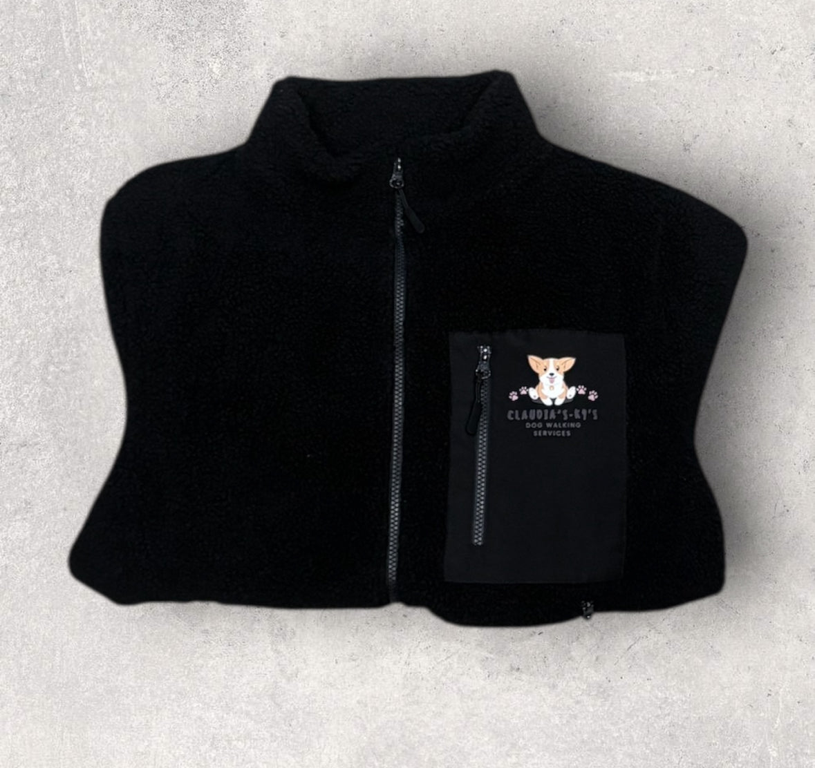 Black fleece workwear garment showing pocket detail