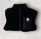 Black fleece workwear garment showing pocket detail