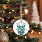 Elegant bow ornament hanging on a decorated Christmas tree.