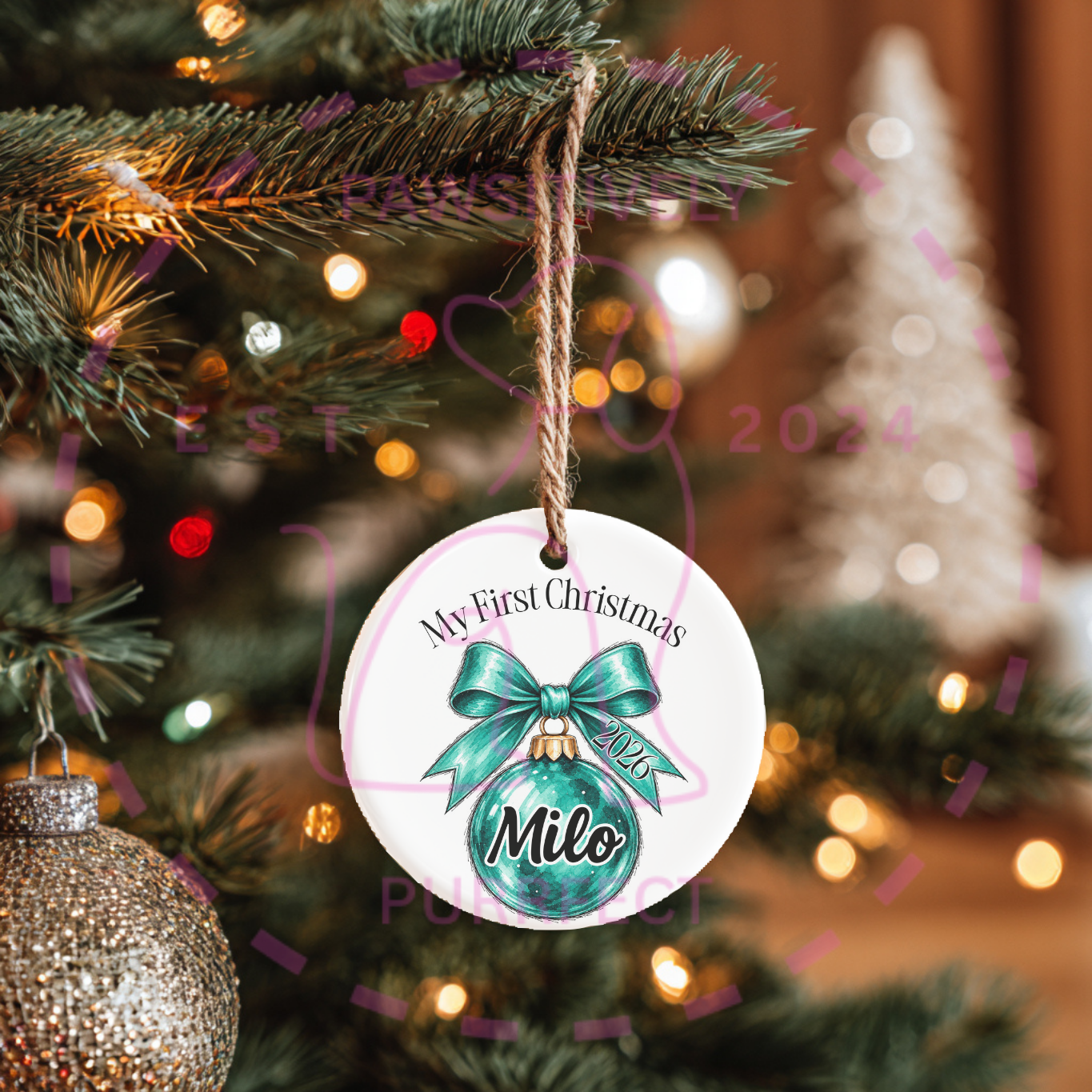 Elegant bow ornament hanging on a decorated Christmas tree.