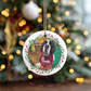 Custom photo festive wreath Christmas bauble hanging on a decorated Christmas tree with family or pet photo.